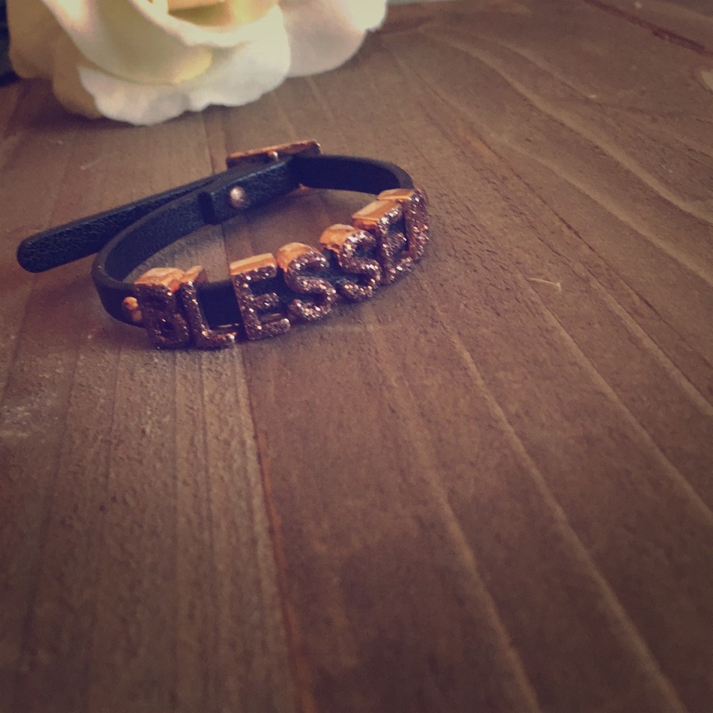 Black leather charm bracelet.